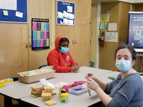 Students packaging Tic-Tac-Toe Boards.